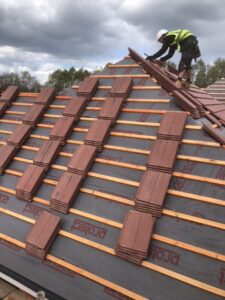 A residential roof with exposed batten that is being replaced with new roof tiles.