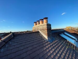 A chimney stack that has been repaired using new mortar and lead flashing.