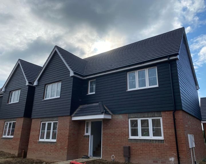 New grey composite cladding installed on the exterior of a house in Gosport.