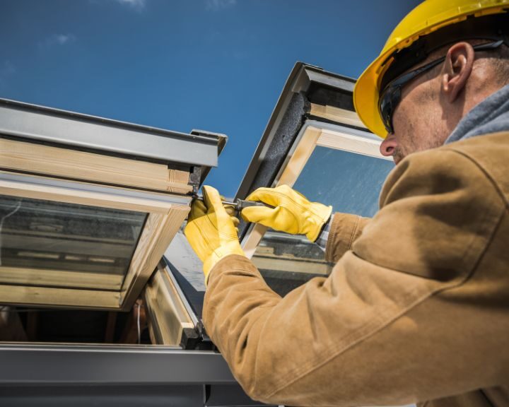 A roofer repairing a dormer window on a roof in Gosport.