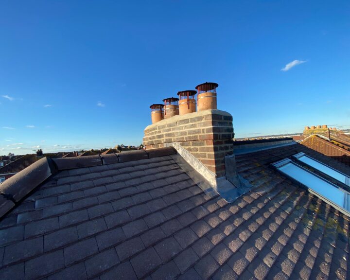 A chimney stack that has been repaired using new mortar and lead flashing.